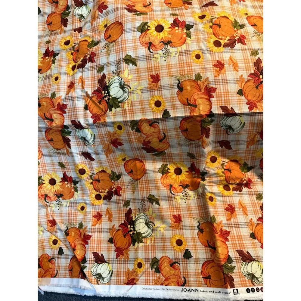Joanne Fabrics harvest-themed pumpkins and sunflowers on a plaid background